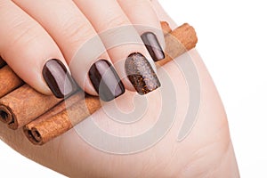 Brown nail polish on the nails.