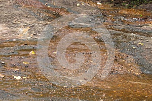 Brown natural wet rocks in river water background