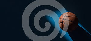 Brown new basketball ball with natural lighting on blue background. Sport team concept. Horizontal sport theme poster, greeting ca