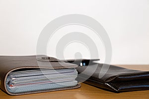 Brown notebook and brown case on a wooden table