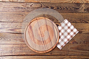 Brown old vintage wooden table with framed checkered tablecloth and pizza cutting board.Thanksgiving day and Cristmas table
