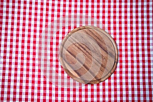 Brown old vintage wooden table with framed red checkered tablecloth and pizza cutting board.Thanksgiving day and Cristmas table