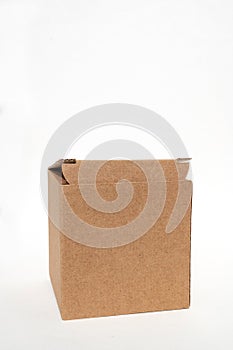 Brown open square corrugated cardboard box on a white background. Cardboard box with an open lid