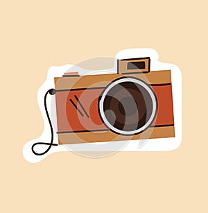 Brown outline vintage camera on beige background