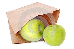 Brown paper bag with green apples
