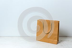 Brown paper bag on table wooden background