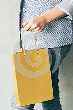 Brown paper bag woman hand consumerism shopping
