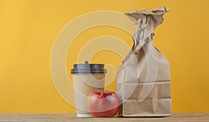 Brown paper bag on wooden background