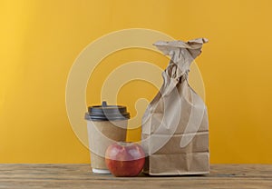 Brown paper bag on wooden background