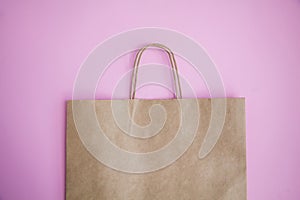Brown paper eco friendly bag on pink background