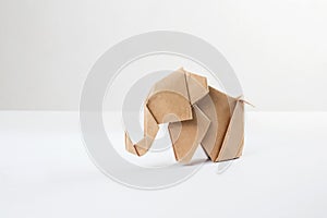 Brown paper origami elephant  on white background