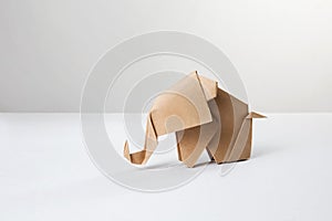 Brown paper origami elephant  on white background