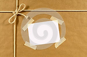 Brown paper package background, address label, sticky tape