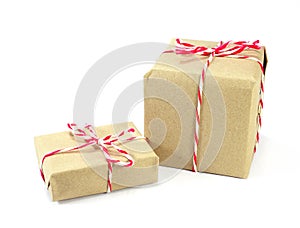 brown paper parcel tied with red and white string on white background