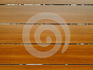 brown parallel fence panels with wood pattern. shiny lacquered finish. slim joints in between.
