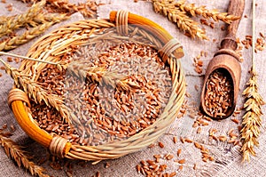 Brown peeled wheat grits on a textile background