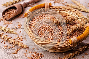 Brown peeled wheat grits on a textile background