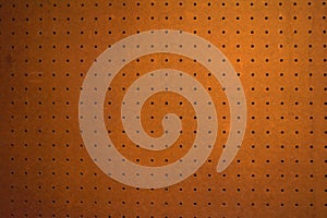 Brown peg board holey background