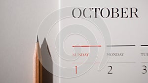 Brown pencil on white calendar