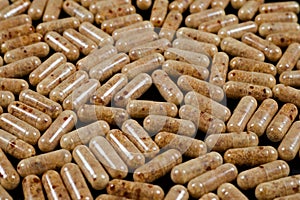 brown pills on a dark background