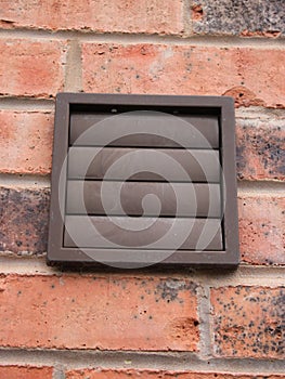Brown plastic air vent on a residential building