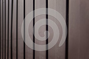 Brown plastic slatted surface. Construction and repair. Background. Space for text