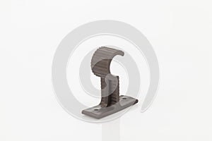 Brown plastic support for curtain poles on white background