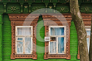 Brown platbands on green wall in Murom