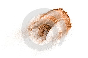 Brown powder dust cloud.Brown particles splattered on white background