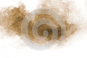 Brown powder dust cloud.Brown particles splattered on white background