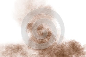 Brown powder dust cloud.Brown particles splattered on white background