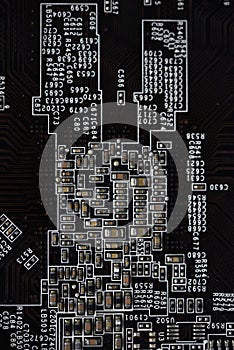 A brown printed circuit board with resistors and capacitors. An electronic board with radio elements