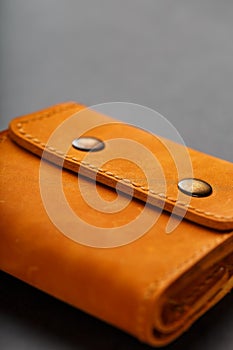 Brown purse, wallet made of genuine leather Nubuck on a dark background. Elements of leather craft products handmade