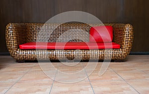 Brown Rattan Wicker Sofa with Red Leather Upholster and Pillow.