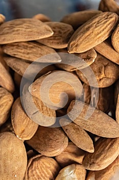 Brown raw almonds pile closeup - Image