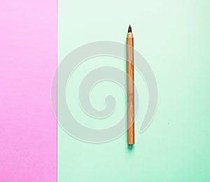 Brown recycled eco pen on two backgrounds: pink and green