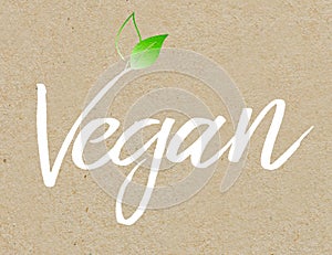 Brown recycled paper background with white coloured lettering vegan