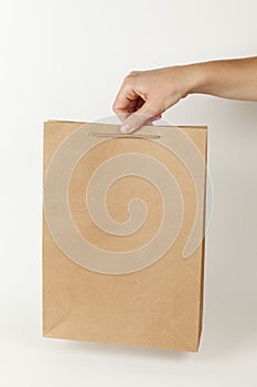 Brown recycled paper bag on white background. Mockup with copy space for text