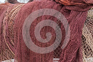 Brown and red fishing nets in a harbour