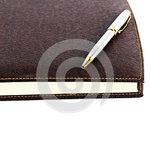 Brown red leather notebook with pen