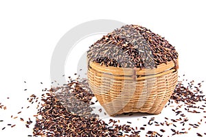 Brown rice or riceberry in bamboo basket isolated on white background