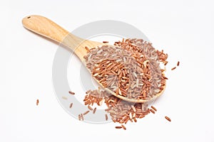 Brown rice with wooden spoon.