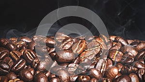 Brown roasted coffee beans seed on dark background. Ãâ¢spresso photo