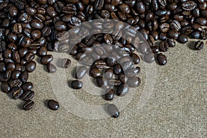 Brown roasted coffee beans, seed on woodenbackground