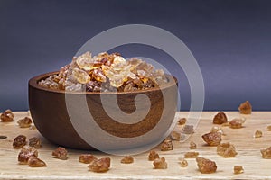 Brown rock sugar in wooden bowl