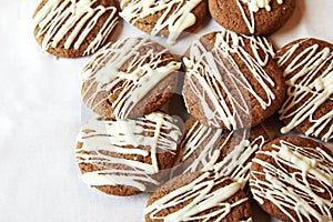 Brown Round Christmas Gingerbread cookies drizzled with White Ch