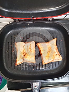 brown seres toast on a black, hot grill photo