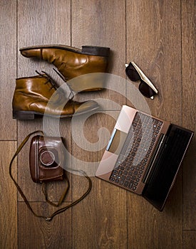 Brown shoes, belt, bag and film camera with laptop