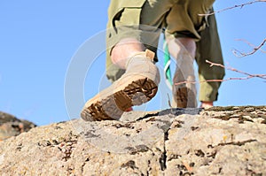 Brown Shoes of a Boy Scout Climbing a Rock