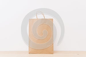 Brown shopping bag wooden surface. High quality and resolution beautiful photo concept